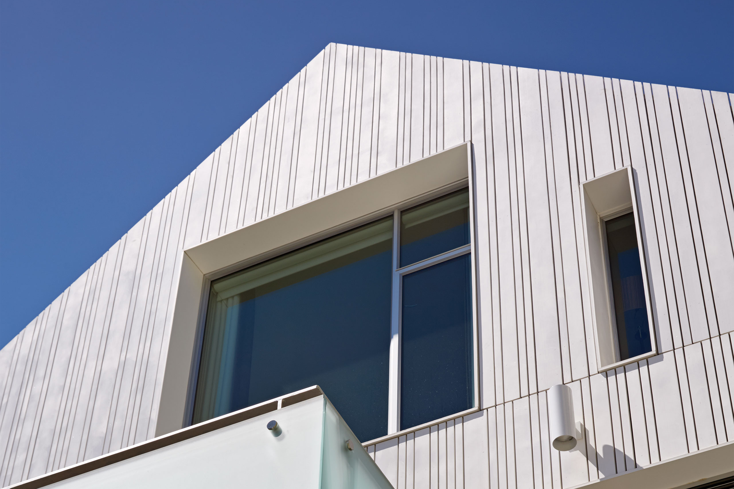 Peaked roof and large window over balcony